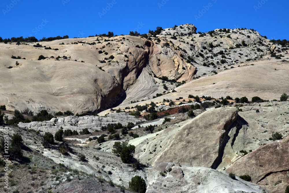 Large rock face set against blue sky