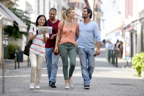 Young people on vacation walking in city street