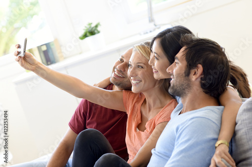 Free Download Group of friends taking selfie pictures with smartphone - GFXLoad