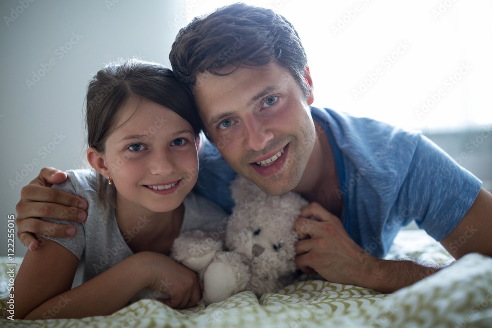 Portrait of father and daughter lying in bedroom Portrait of father and daughter lying in bedroom