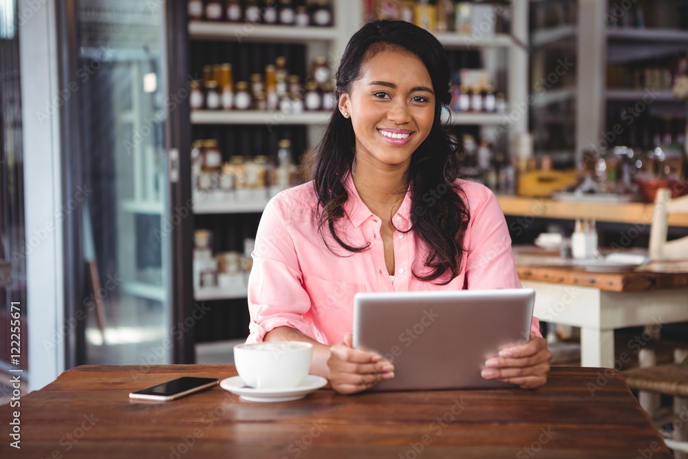 Portrait of beautiful woman holding digital tablet Portrait of beautiful woman holding digital tablet