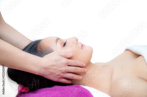 Beautiful woman is getting a facial massage in the spa salon