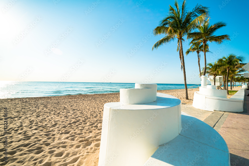 Deserted Fort Lauderdale South Florida beach with iconic spiral wall and palm trees under brilliant blue sky Deserted Fort Lauderdale South Florida beach with iconic spiral wall and palm trees under brilliant blue sky