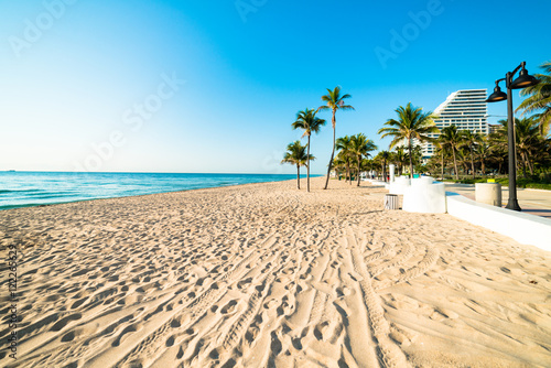 Fototapeta Naklejka Na Ścianę i Meble -  White sand deserted Fort Lauderdale South Florida beach stretching out under beautiful blue cloudless sky
