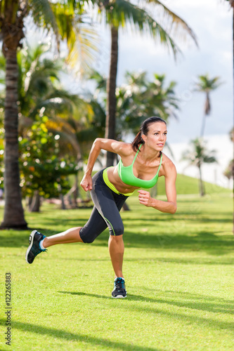 Young woman exercising in tropical park