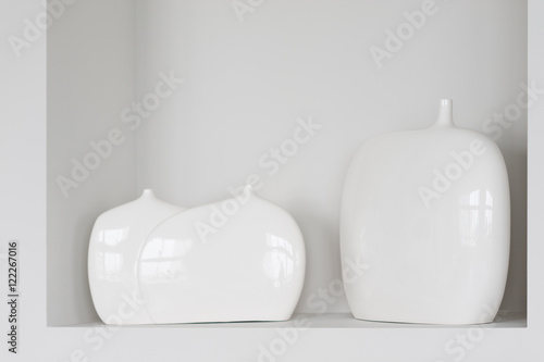 Fototapeta Three white vases in wall alcove