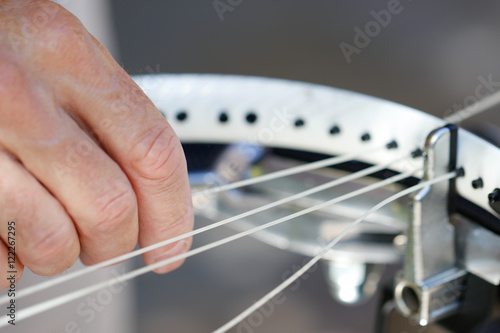 Objects: Man stringing tennis racket