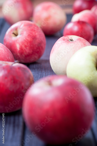 ripe red apples on a table selective focus vertical photo