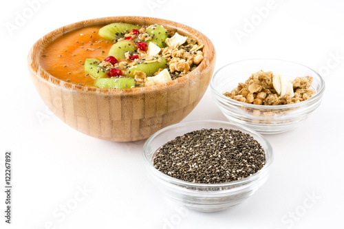 Healthy smoothie with fruit, cereals and chia seeds in a bowl isolated on white background 