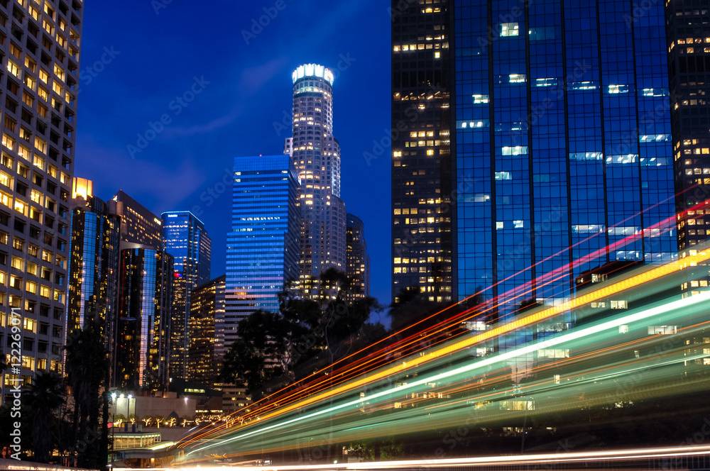 Deep blue twilight Los Angeles Skyline with dynamic diagonal red green yellow light streaks racing through Deep blue twilight Los Angeles Skyline with dynamic diagonal red green yellow light streaks racing through