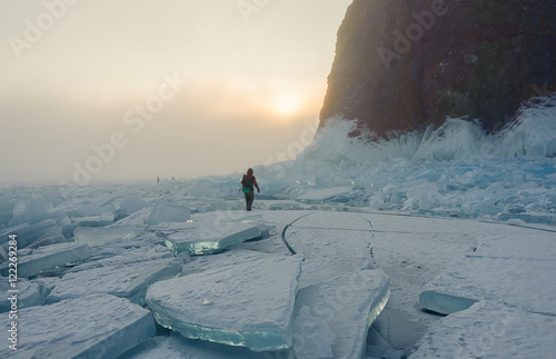 man walking in the fog on the ice of lake Baikal