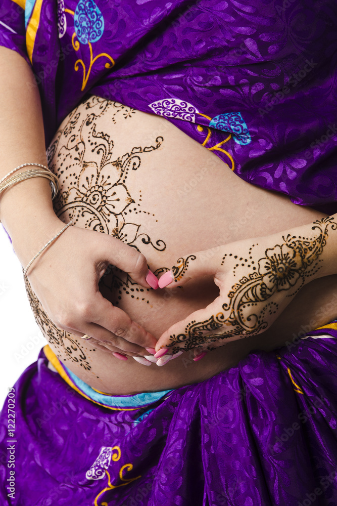 Premium Photo  Studio portrait of a pregnant woman in indian sari, a  pregnant belly painted with henna