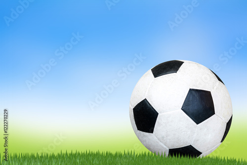 Soccer ball on the grass.Blur Background grass and sky