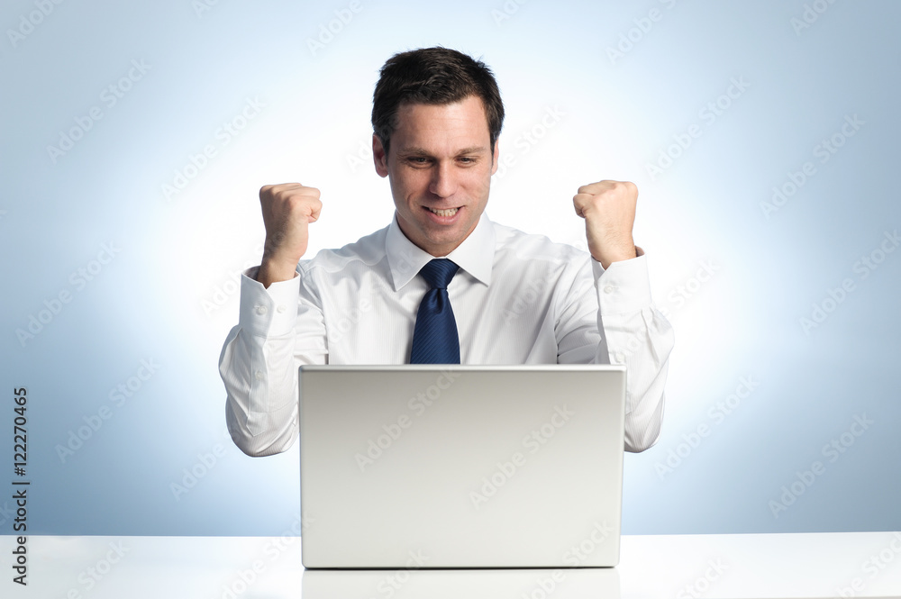 Businessman celebrates with laptop computer Businessman celebrates with laptop computer