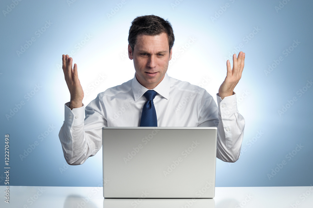 Businessman frustrated with laptop computer Businessman frustrated with laptop computer