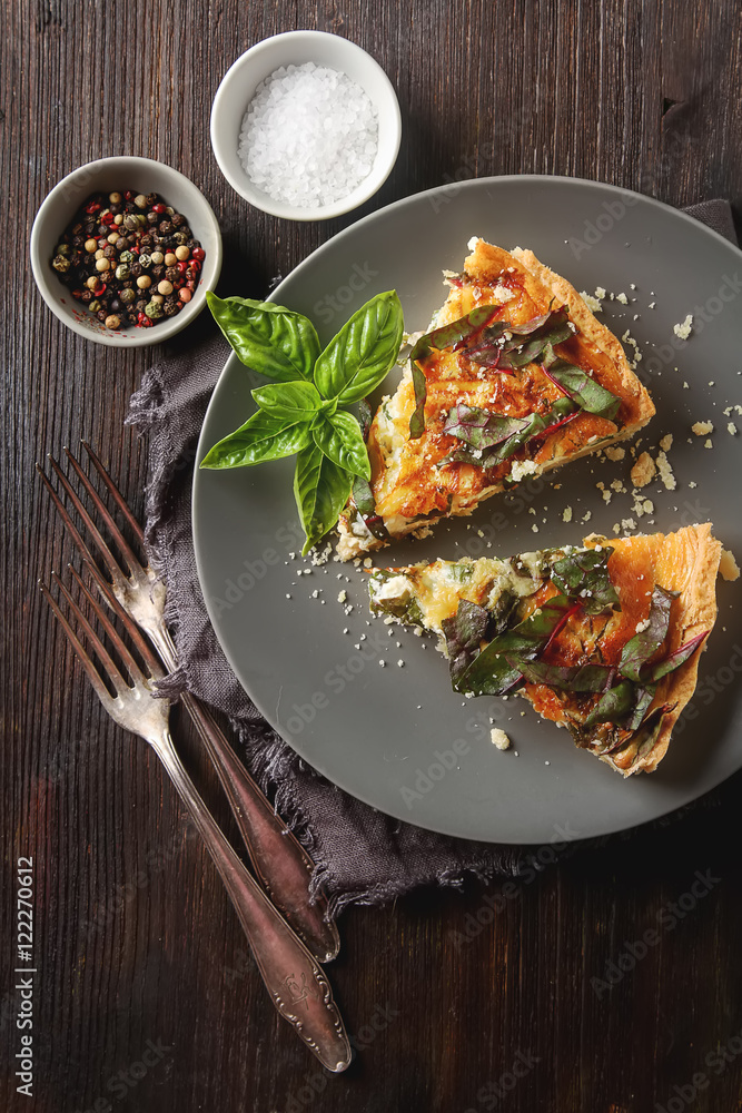 Traditional French cake. quiche with chard on the gray plate wit