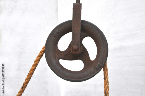 Iron pulley with jute rope. photo