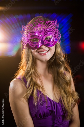 Woman wearing masquerade in bar