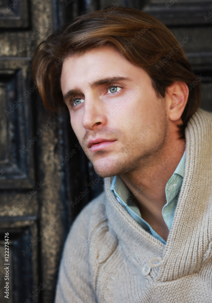 Fototapeta premium Portrait of appealing young man awaiting near the door