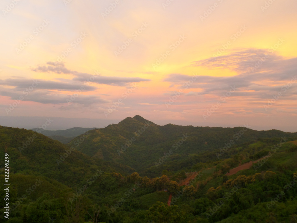 Pastel Yellow and Purple of the after sunset sky over Mountain Range, Highland of Thailand 
