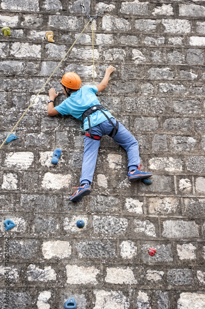 teenage boy in a free climbing wall