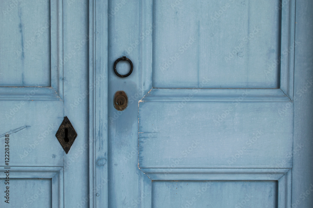 Knocker and lock on the blue wooden door