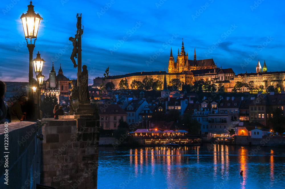 Stunning view of the illuminated Prague just after sunset. The Castle Complex, from the Charles bridge