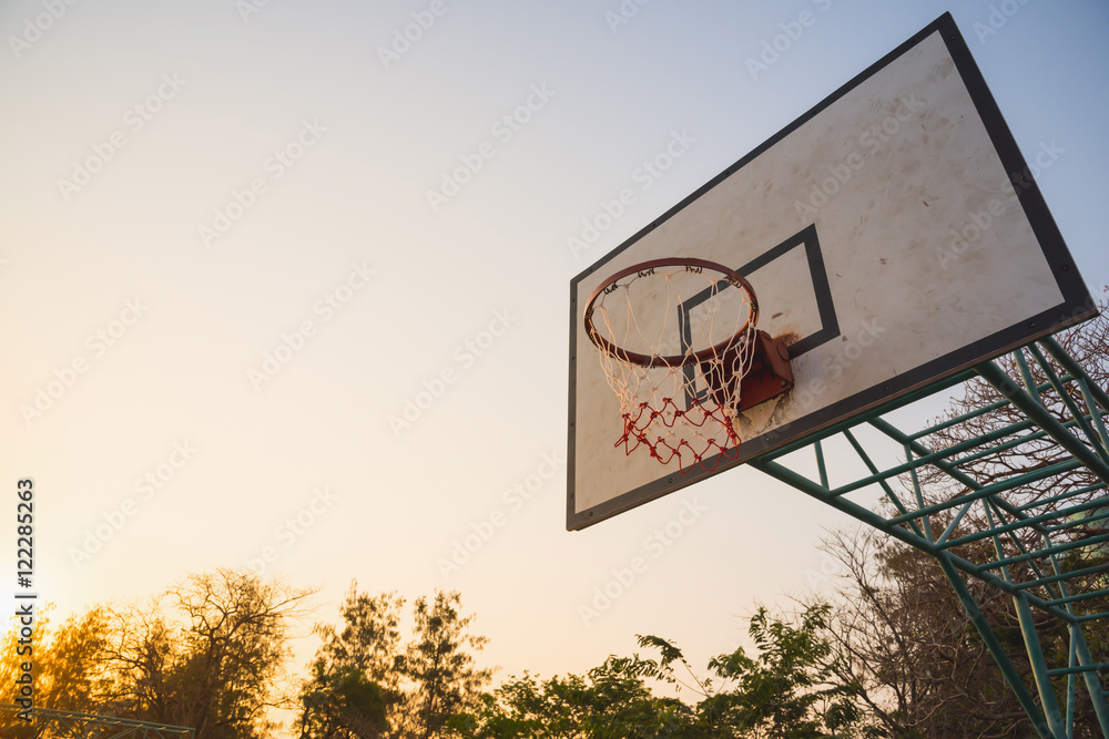 Basketball hoop in the park in the evening
