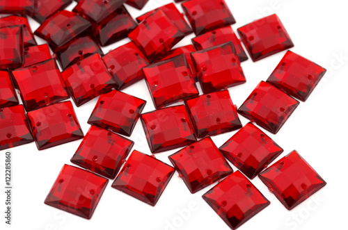 Crimson-red rhinestone on white background