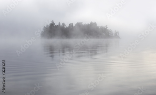 Island in the fog on Lake of Two Rivers in Algonquin Park, Canada