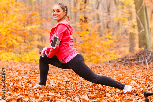 Fit girl doing stretching outdoor.