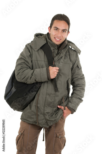 latin guy wearing coat and backpack posing with hand on pocket