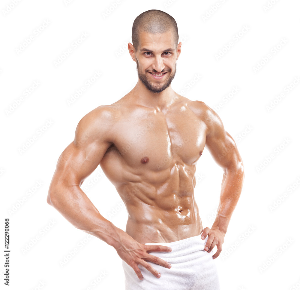 Smiling fit man posing in towel, isolated on white background Smiling fit man posing in towel, isolated on white background