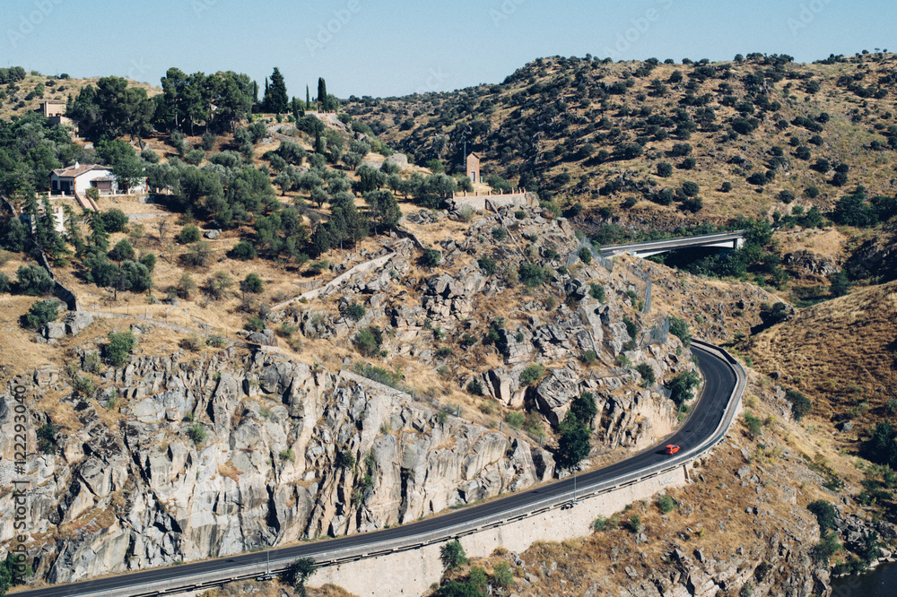 Red car alone on the road in mountains