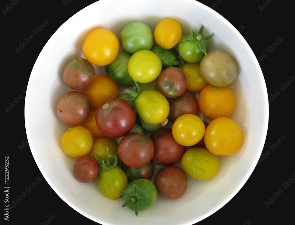 Diverse cherry tomatoes on a round plate Diverse cherry tomatoes on a round plate