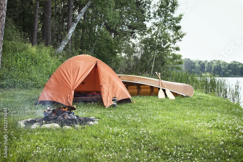 Tent, campfire and canoe on Minnesota lakshore
