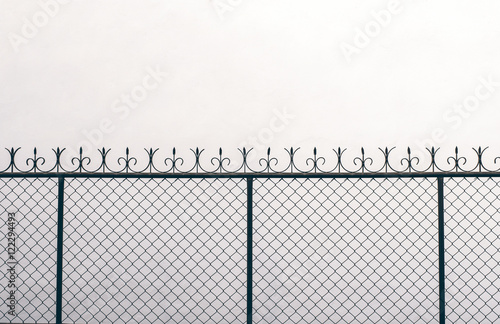 Old rusted metal screen on white painted concrete wall for abstr