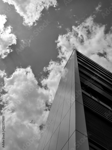 Low angle view on building and clouds in black and white