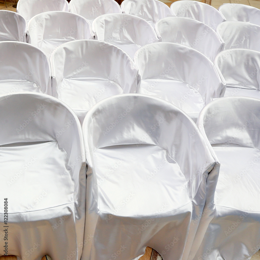 Fototapeta premium Chairs covered with white cloth on wedding ceremony