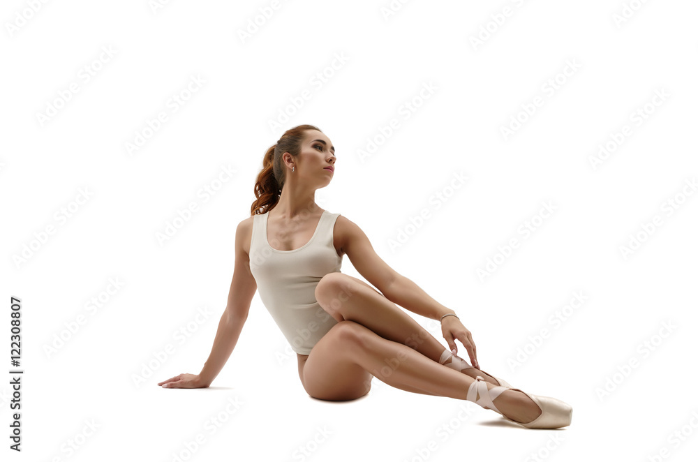 Beautiful ballet dancer sitting. Isolated on white Beautiful ballet dancer sitting. Isolated on white