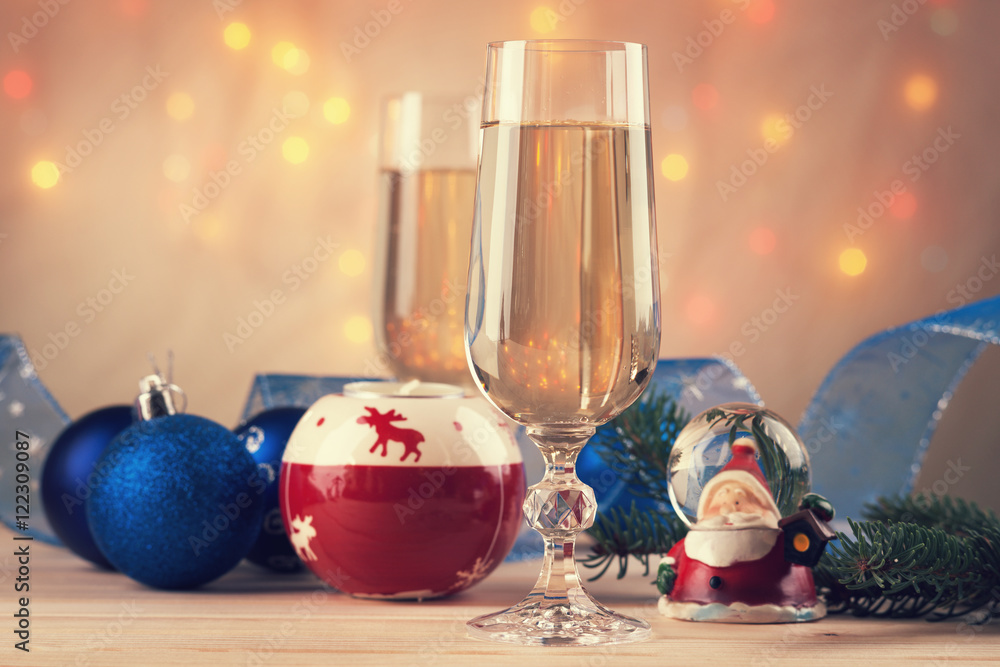 Christmas balls, ribbon, snow globes and champagne 