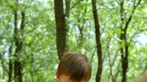 Cute little boy playing on a seasaw in the park photo