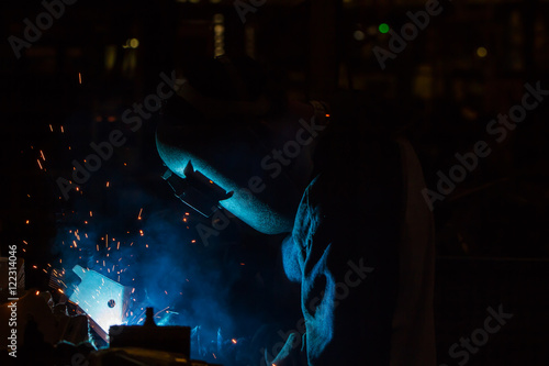 The movement of workers with protective mask welding metal.