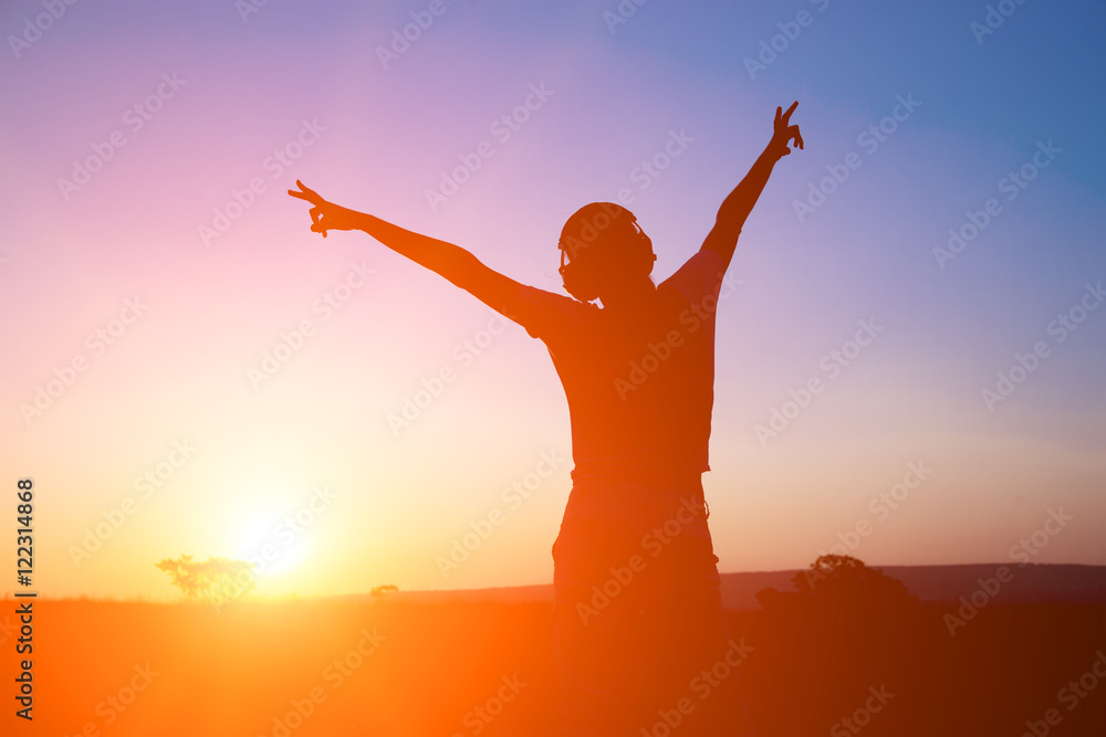 Silhouette young woman with headphone on sunrise background. Silhouette young woman with headphone on sunrise background.