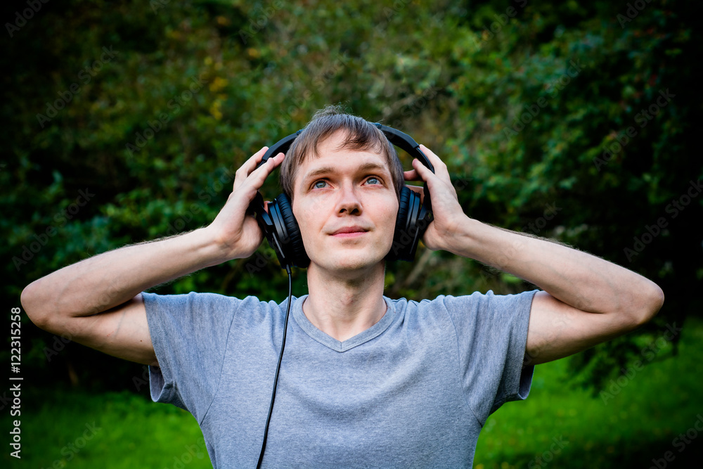 A man with two hands presses the headphones on your ears.
A man with two hands presses the headphones on your ears.