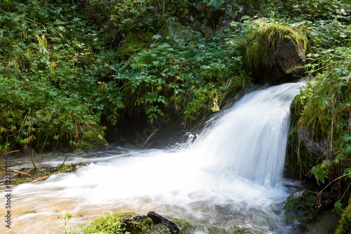 Fototapeta Naklejka Na Ścianę i Meble -  beautiful small waterfall on the river