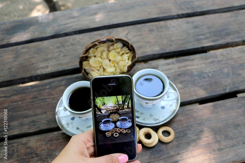 two cups filled with coffee and cereal in nature, phone copy this nature picture