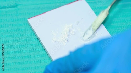 Dentist To Mix Cement With A Metal Spatula