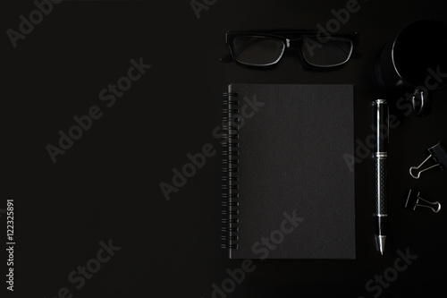 Black notebook with copyspace and cup of coffee