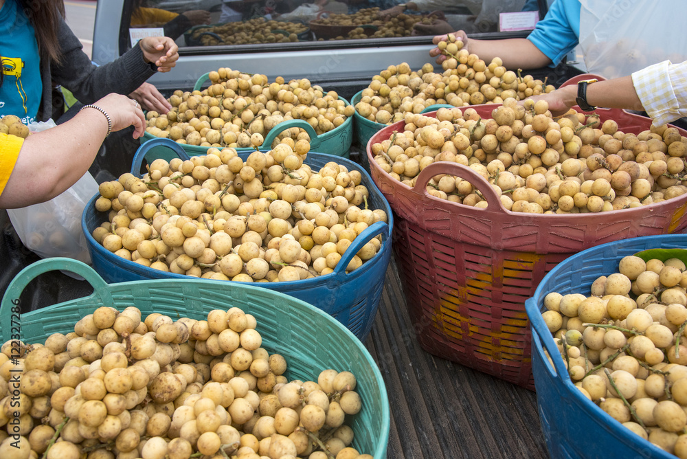 Longkong on scales , Customers are buying Longkong fruit (Lansium )